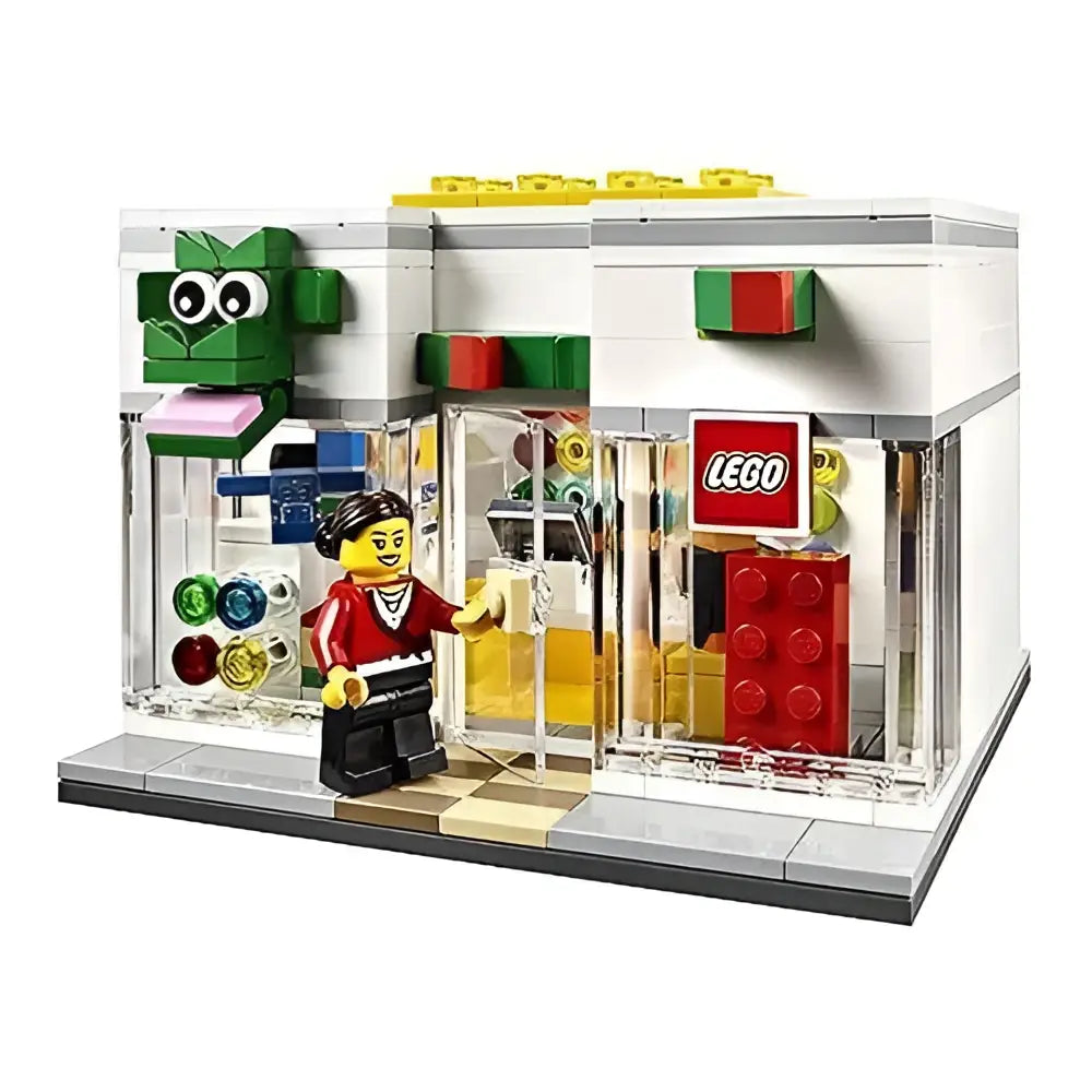 Weißer lego store 40145 mit grünem froschlogo, roter weißer beschriftung und bunten lego steinen zum spielzeug online kaufen